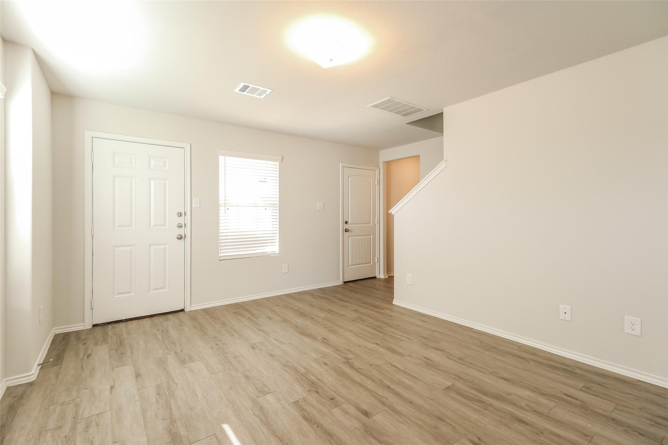 3229 Chunk Court Conroe, TX 77301 - Photo 6 of 18 an empty room with wooden floor and windows