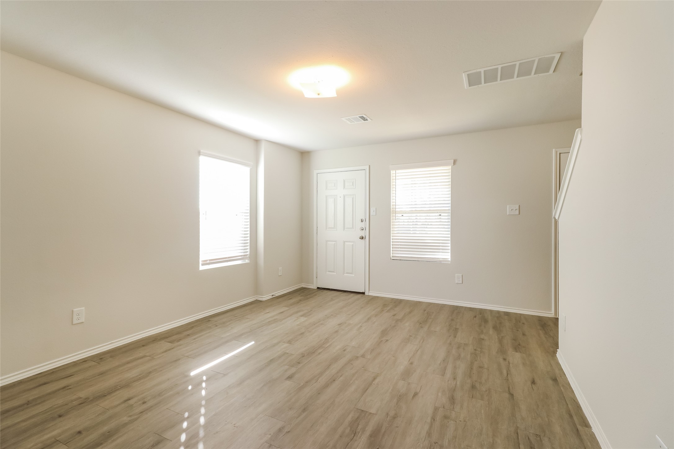 3229 Chunk Court Conroe, TX 77301 - Photo 7 of 18 an empty room with wooden floor and windows