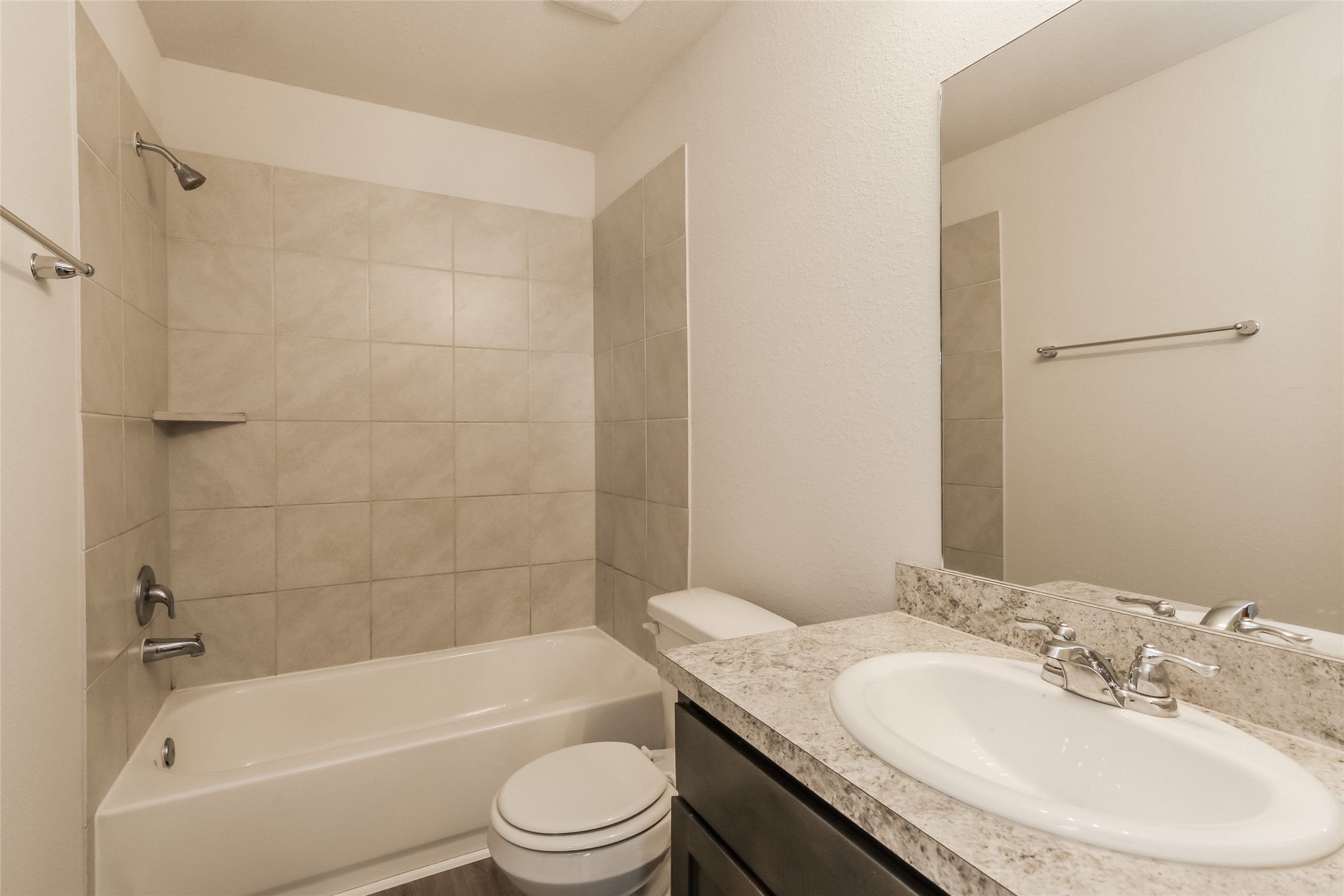 3229 Chunk Court Conroe, TX 77301 - Photo 10 of 18 a bathroom with a granite countertop bathtub shower sink vanity mirror and toilet