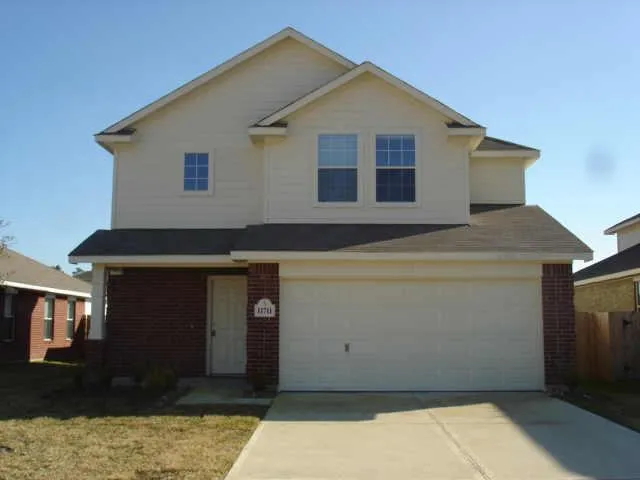 a front view of a house with parking space
