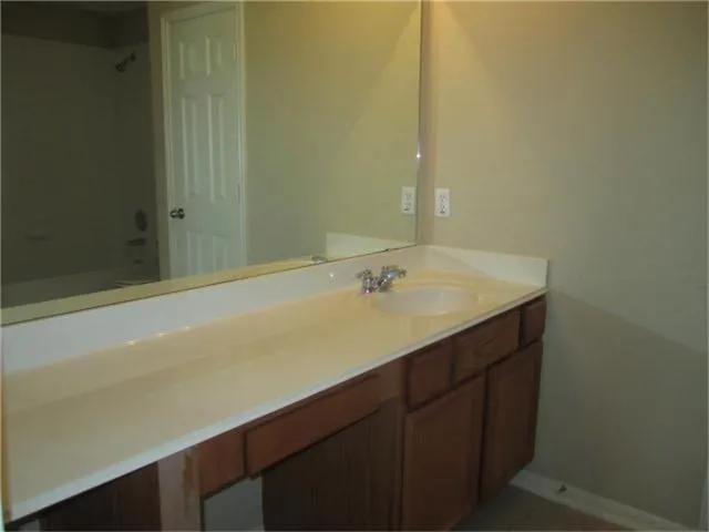 a white toilet sitting next to a bath tub