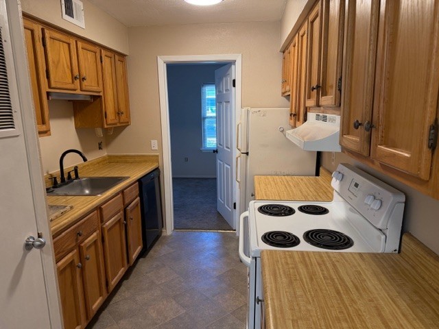 622 Beach Access Road, Unit 228 Port Aransas, TX 78373 - Photo 8 of 12 a kitchen with stainless steel appliances a sink and a refrigerator