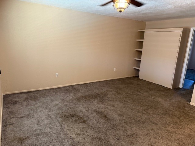 622 Beach Access Road, Unit 228 Port Aransas, TX 78373 - Photo 10 of 12 an empty room with a ceiling fan and carpet