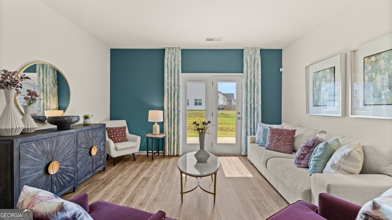 11940 Aukerman Way Hampton, GA 30228 - Photo 24 of 32 a living room with furniture and a wooden floor