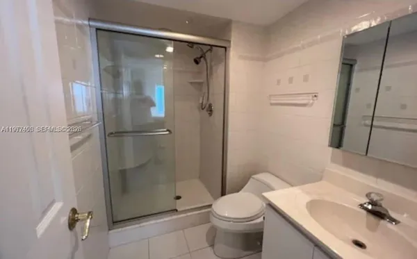 a bathroom with a shower and a sink