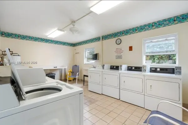 a kitchen with cabinets and chairs