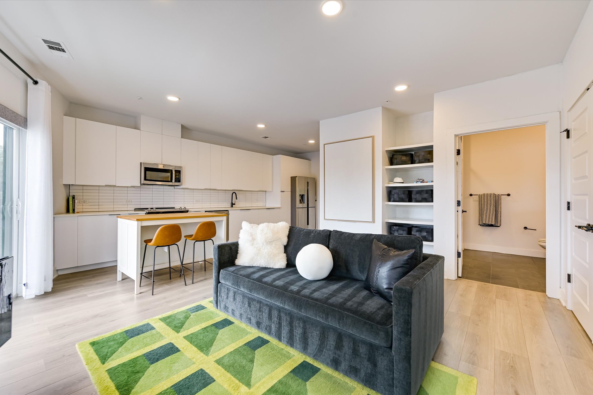 2220 Webberville Road, Unit 308 Austin, TX 78702 - Photo 3 of 21 Open-concept living area with wood-finish flooring