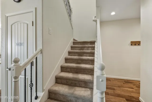 a view of staircase with white walls and railing
