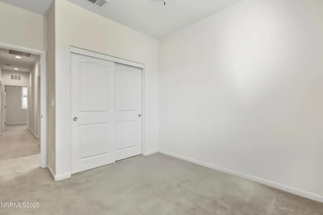 an empty room with closet area
