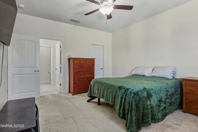 a spacious bedroom with a bed and a cabinets