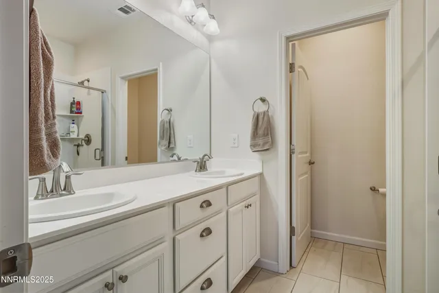 a bathroom with a double vanity sink mirror and double