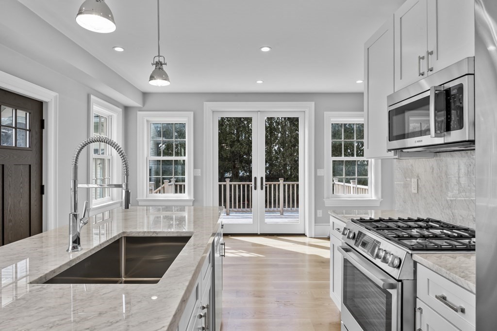 a kitchen with granite countertop a stove and a sink