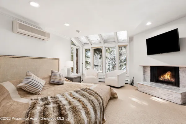 a bedroom with a bed and a fireplace