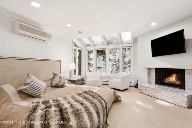 a bedroom with a bed and a fireplace