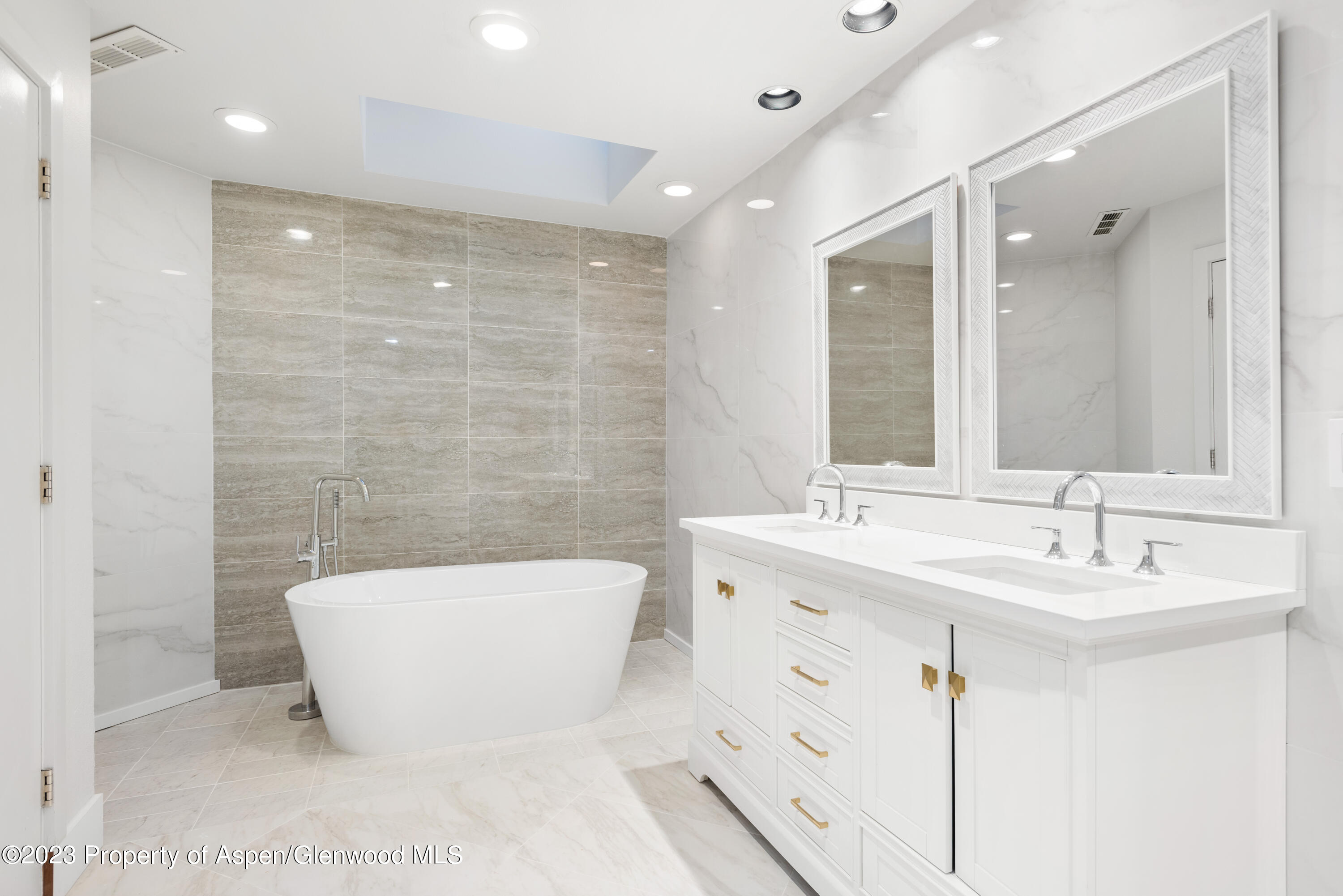 1436 Crystal Lake Road, Unit 4B Aspen, CO 81611 - Photo 13 of 22 a bathroom with a large tub a sink a toilet and a shower