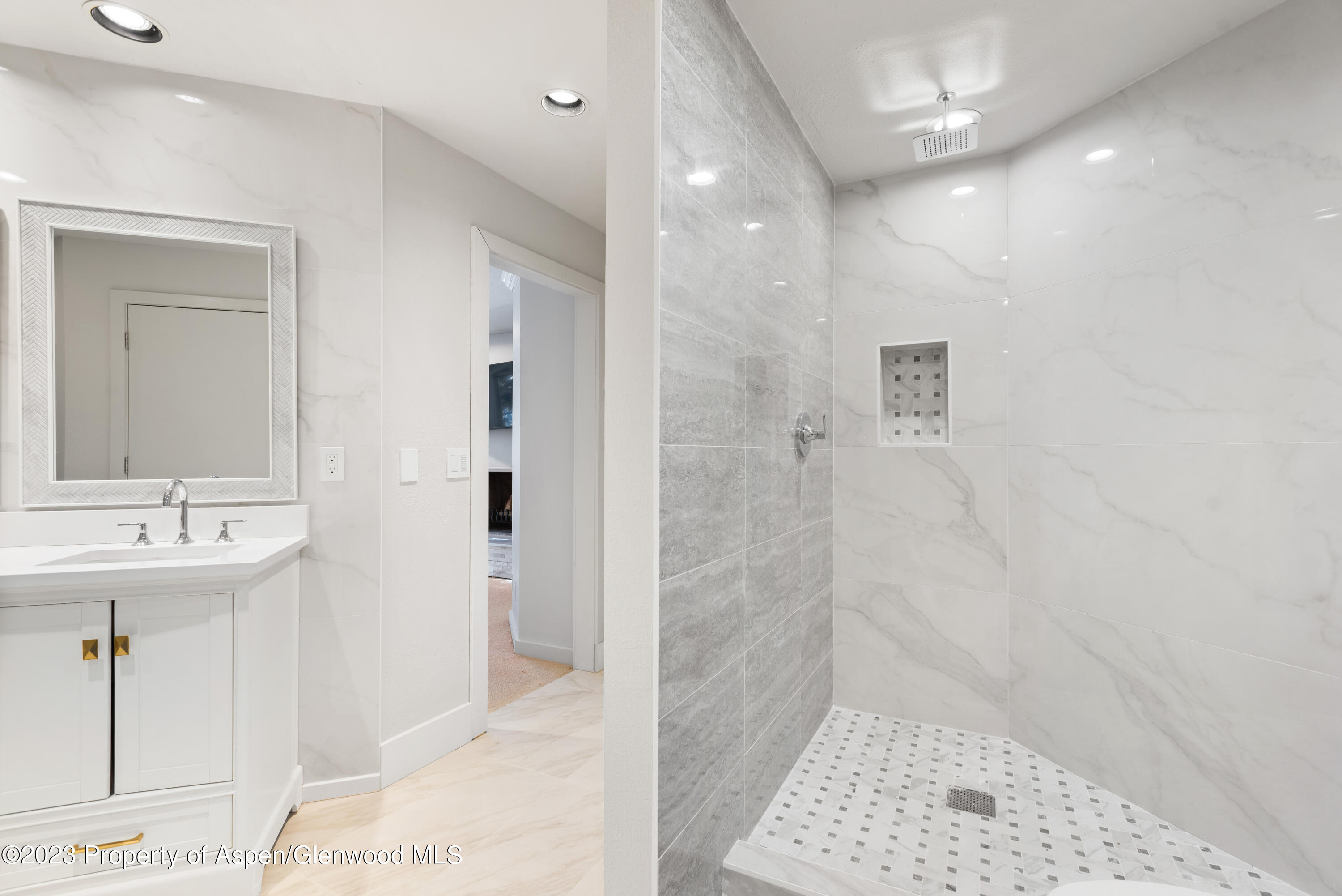 1436 Crystal Lake Road, Unit 4B Aspen, CO 81611 - Photo 14 of 22 a bathroom with a sink a toilet a shower and a mirror