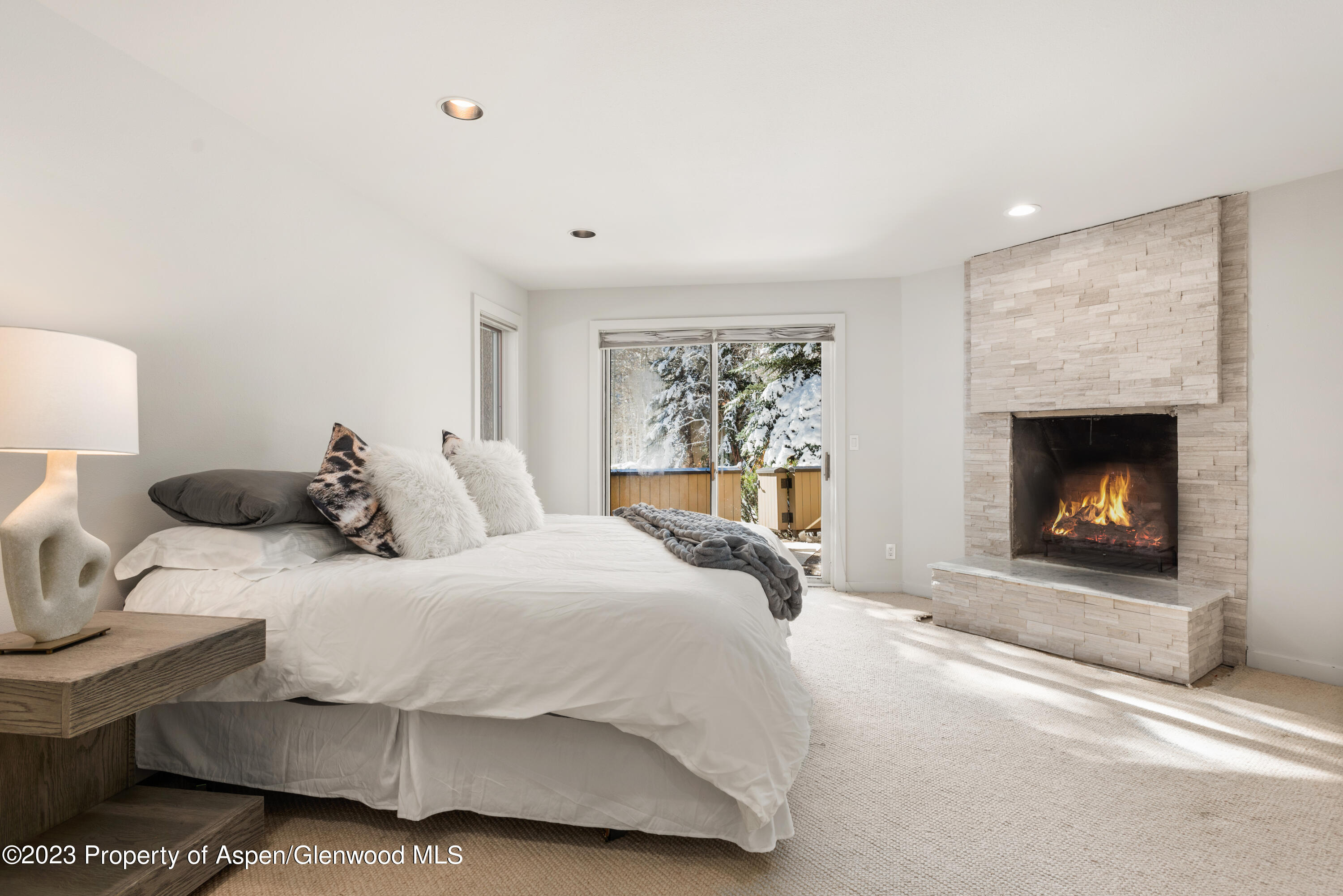 1436 Crystal Lake Road, Unit 4B Aspen, CO 81611 - Photo 15 of 22 a bedroom with a bed and a fireplace