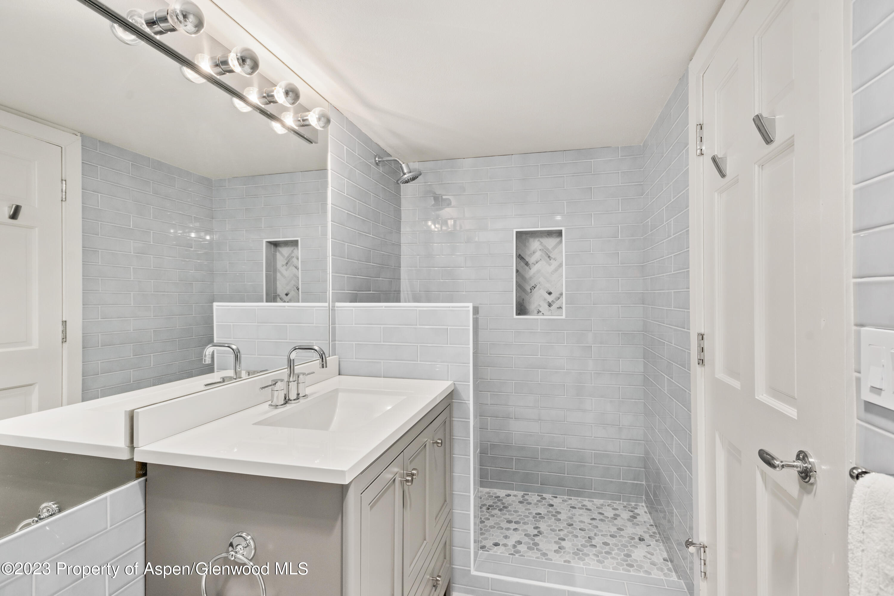1436 Crystal Lake Road, Unit 4B Aspen, CO 81611 - Photo 17 of 22 a bathroom with a sink a shower and a mirror