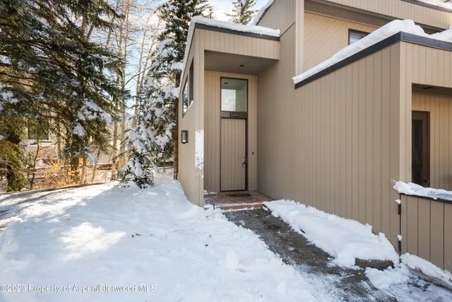 a view of a house with a snow in the yard