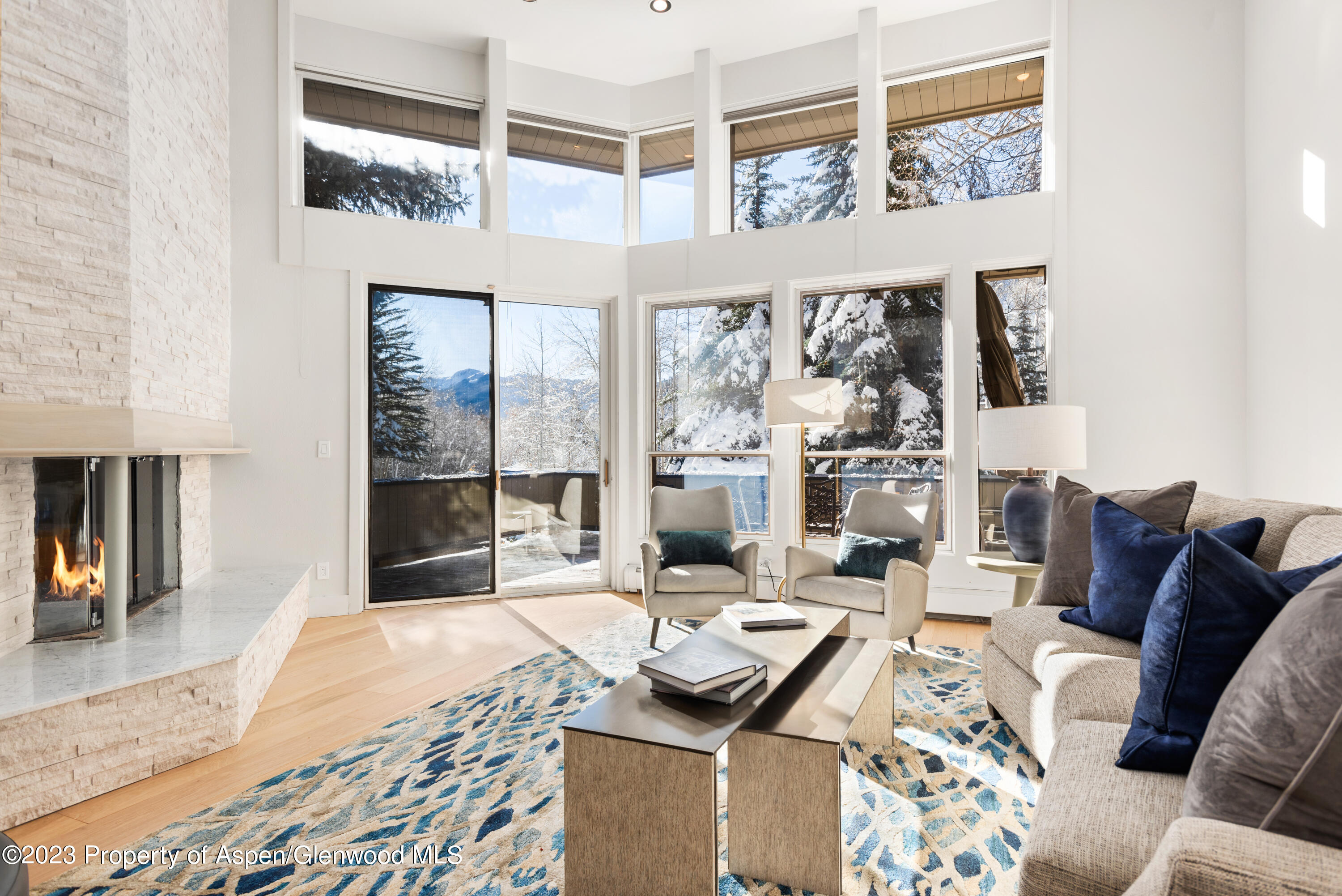 1436 Crystal Lake Road, Unit 4B Aspen, CO 81611 - Photo 2 of 22 a living room with furniture and a floor to ceiling window