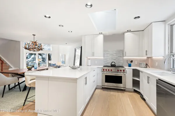 a kitchen with a white cabinets and stove