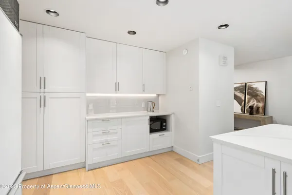 a view of kitchen with cabinets and wooden floor