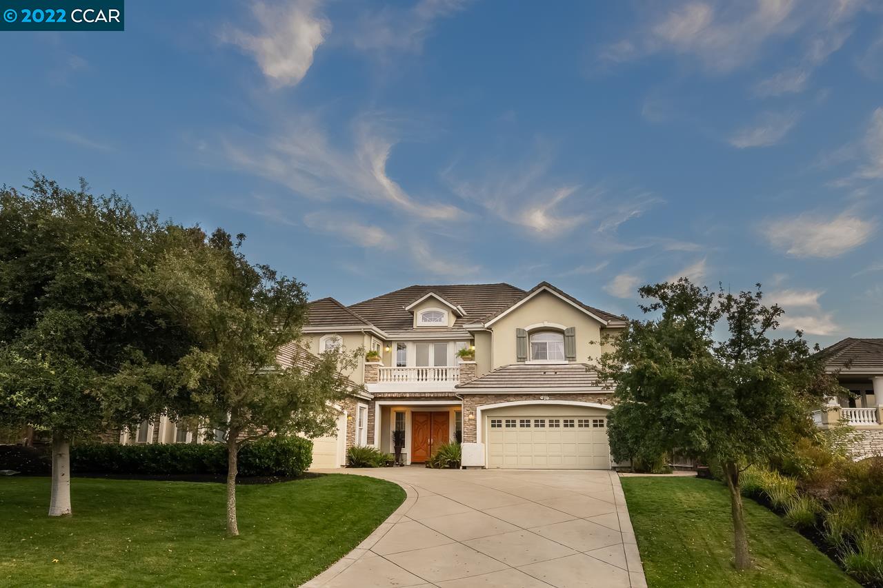 a view of residential houses with yard and tree in the background