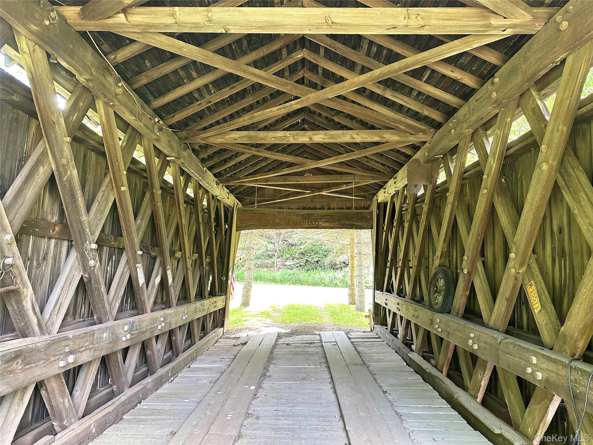 818 Methol Road Roscoe, NY 12776 - Photo 8 of 39 Interior of the historic Campbell Covered Bridge showcasing its original timber truss construction and remarkable historic character.