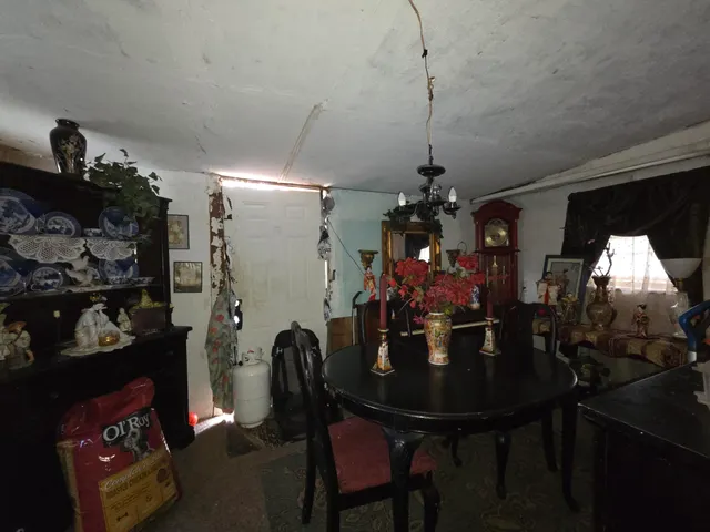 a view of a dining room with furniture and chandelier
