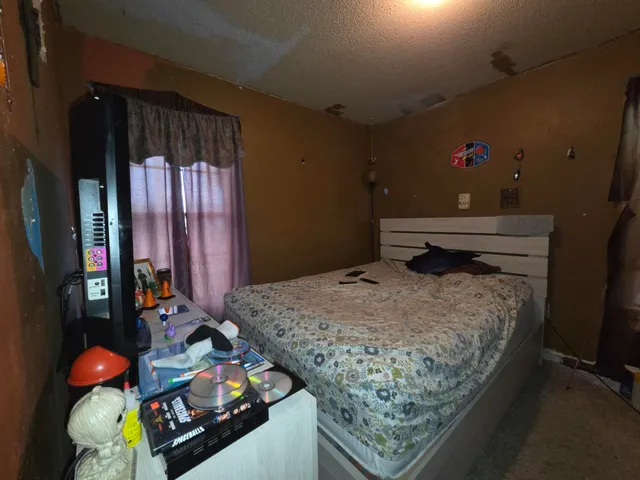 a bedroom with bed and window