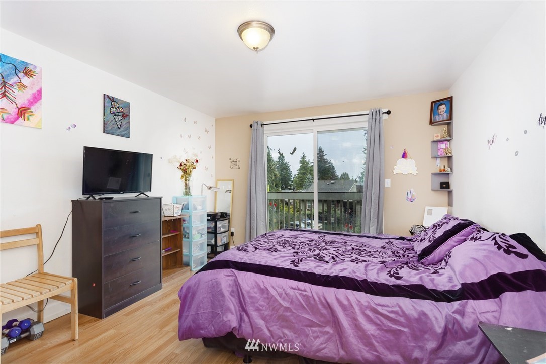 3935 Mason Loop Road Tacoma, WA 98409 - Photo 15 of 24 a bedroom with a bed and a flat tv screen on dresser