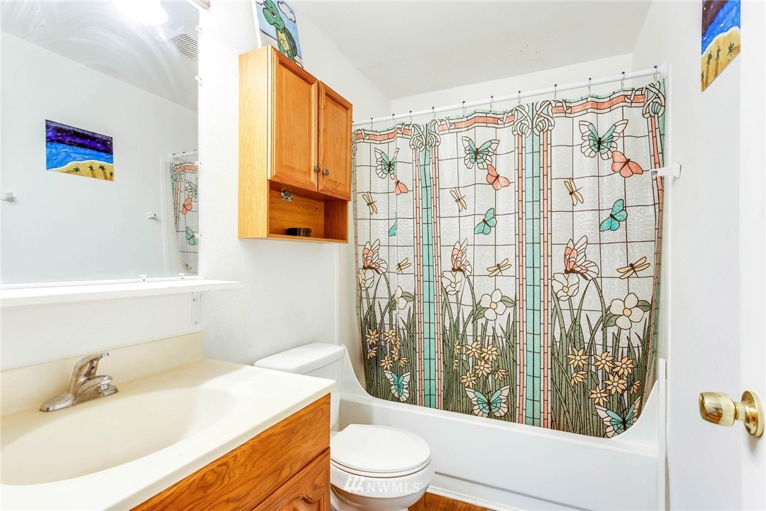 3935 Mason Loop Road Tacoma, WA 98409 - Photo 21 of 24 a bathroom with a sink toilet and shower