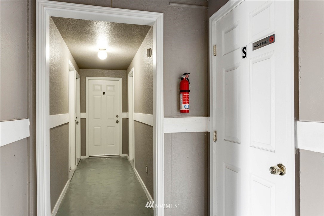 3935 Mason Loop Road Tacoma, WA 98409 - Photo 4 of 24 a very nice looking hallway with a white walls