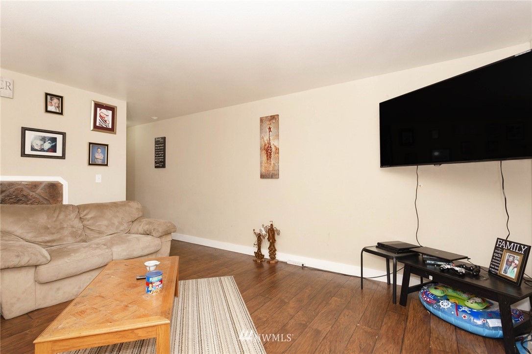3935 Mason Loop Road Tacoma, WA 98409 - Photo 6 of 24 a living room with furniture and a flat screen tv
