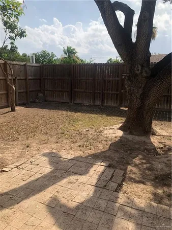 a view of wooden fence next to a yard