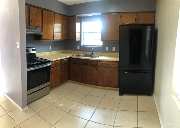 a stove top oven sitting inside of a kitchen