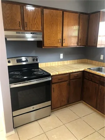 a kitchen with a refrigerator and a sink