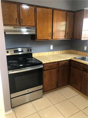 a kitchen with a refrigerator and a sink