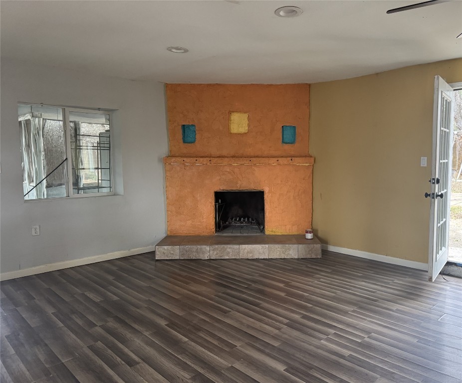 6304 Hudson Bend Road Austin, TX 78734 - Photo 7 of 9 Unfurnished living room with a fireplace and dark wood finished floors