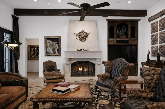 a living room with furniture ceiling fan and a window