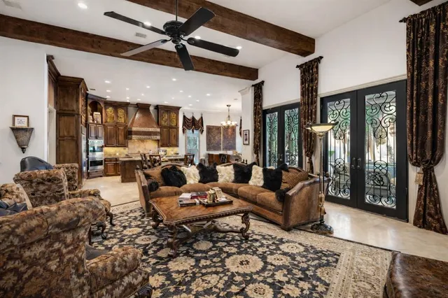 a kitchen with stainless steel appliances kitchen island granite countertop a table chairs sink and cabinets