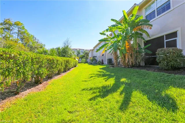 a view of a garden with a building in the background