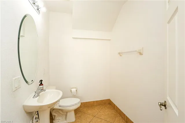 a bathroom with a sink toilet and a mirror