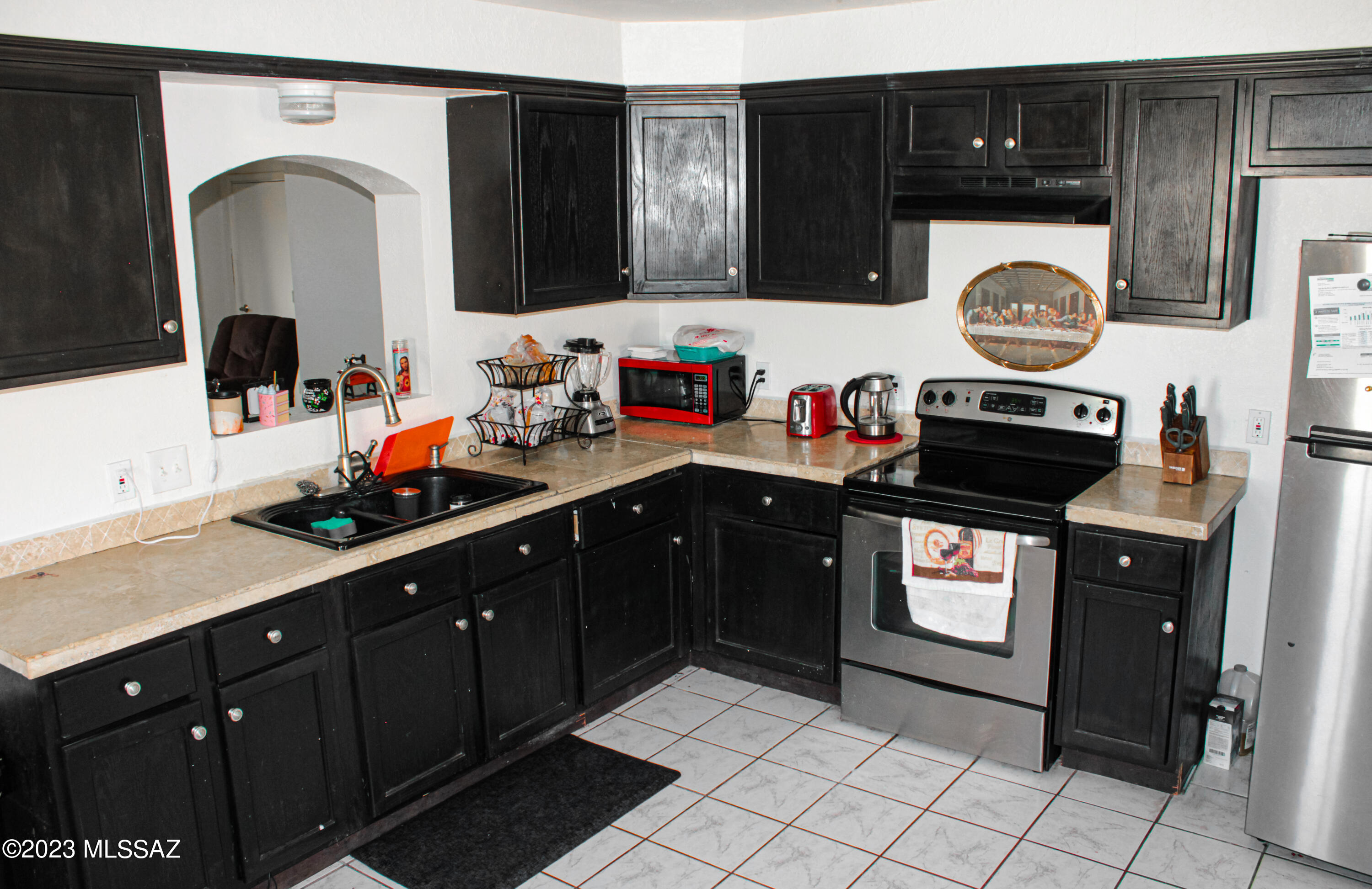 282 Paseo Mascota Rio Rico, AZ 85648 - Photo 8 of 18 a kitchen with stainless steel appliances granite countertop a refrigerator and a stove top oven