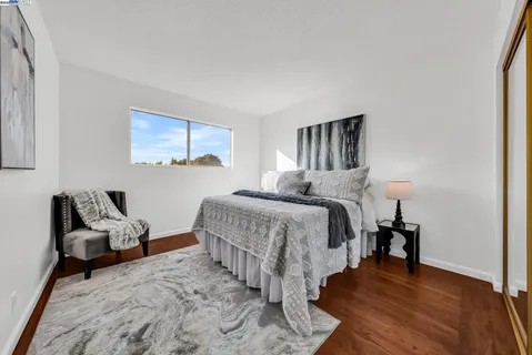 a bedroom with a bed and a couch