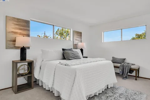 a bed room with a bed and a chair