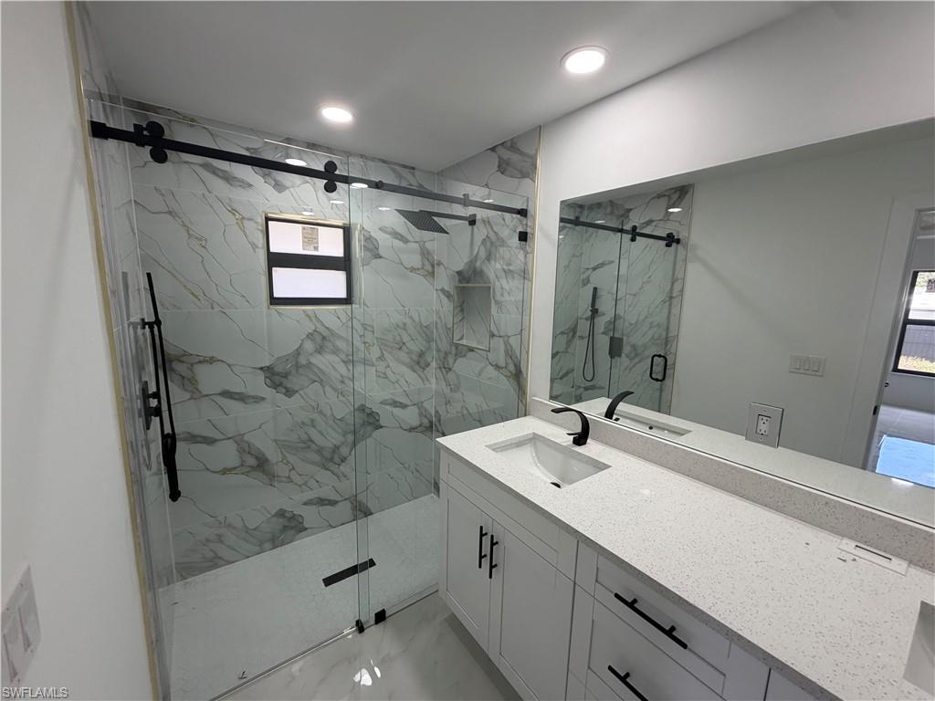 15 Louisiana Road Lehigh Acres, FL 33936 - Photo 3 of 22 a bathroom with a sink a toilet and shower