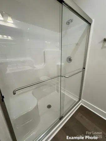 a bathroom with a glass shower door