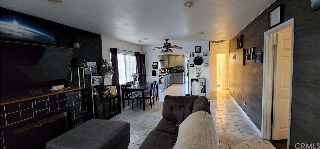 3727 Roosevelt Street Riverside, CA 92503 - Photo 1 of 1 a living room with furniture a flat screen tv and a refrigerator