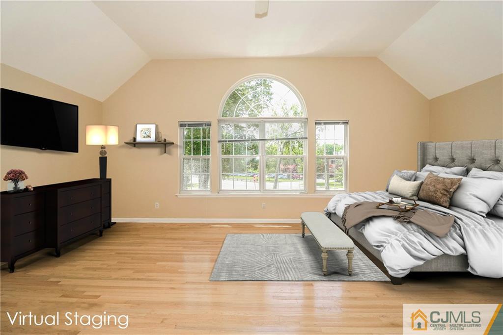 1 Daniel Road Edison, NJ 08820 - Photo 14 of 24 a spacious bedroom with a bed and a flat screen tv